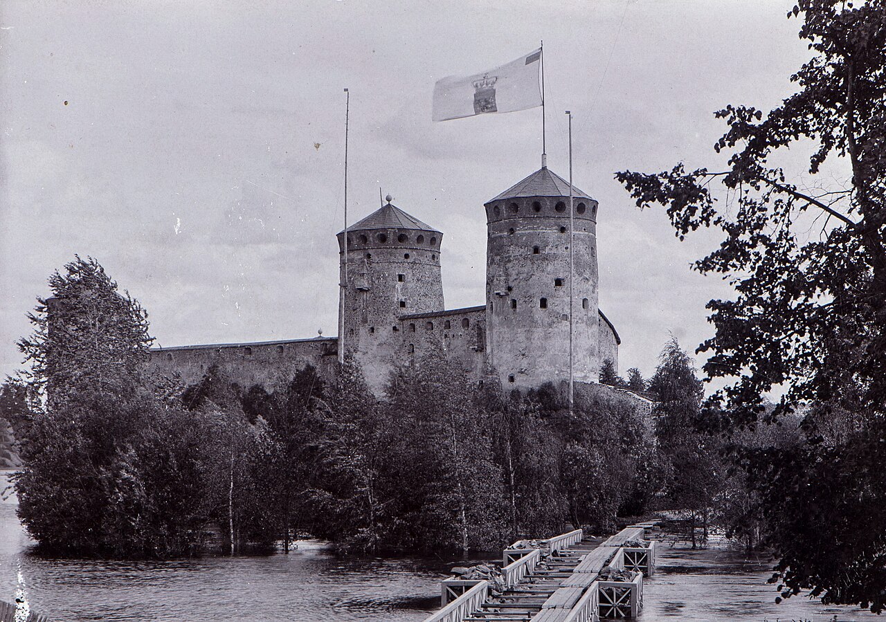 Olavinlinna photographed in 1875, the year of its quatercentenary — a romantic ruin, rediscovered by a national-minded age just as it seemed ready to slide into the lake (Finnish Heritage Agency, CC BY 4.0).